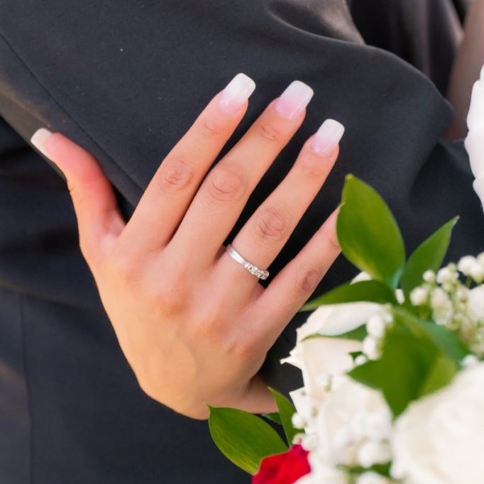 person wearing silver ring and ring